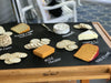 Image of cheese assortment with cheese names identified written on chalkboard paper with Chalk Ink white liquid chalk marker  